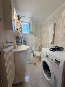 a bathroom with a washing machine and a sink at Molyvos Sunset Horizon in Mythimna