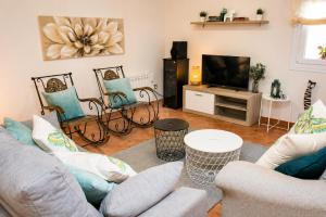 a living room with a couch and a tv at Hospedium Galitrips Vila Maruja Corme in Corme-Puerto