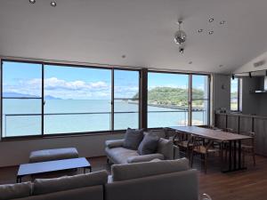 a living room with a couch and a table at Villa JacoO 2 in Sanuki