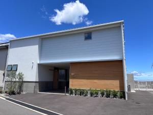 a garage building with a large wooden garage door at Villa JacoO 2 in Sanuki