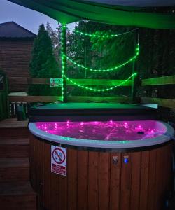 a hot tub with green lights on top of it at Domki Anastazewo in Anastazewo