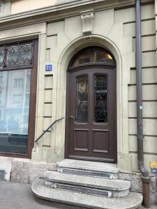 a brown door on the side of a building at Flat 12-min walk to Bern station in Bern