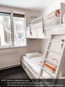 a bunk bed in a small room with a bunk bed in a room at Ajax Ski Club in Mount Buller