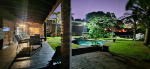 a backyard with a swimming pool and a house at Daniel's Sunset Garden in Richards Bay