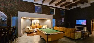 a living room with a pool table and a tv at Daniel's Sunset Garden in Richards Bay