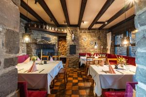 a restaurant with tables and chairs in a room at Zum Alten Turm in Hennef