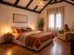 a woman sitting in a chair in a bedroom at Villa Kahuna Sotogrande in Sotogrande +12 photos