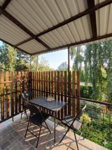 a screened in porch with a table and chairs at У Олексія in Karolino-Buhaz