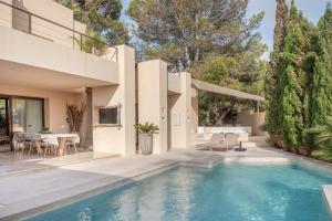 a house with a swimming pool and a patio at La Villa in Illes Balears