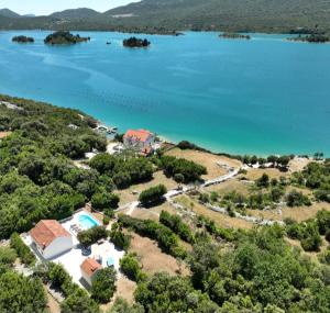 an aerial view of a house and a lake at Beachfront Villa with Swimming Pool, Terrace and Sea view in Ston