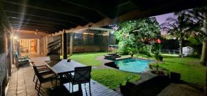 a backyard with a table and a swimming pool at Daniel's Sunset Garden in Richards Bay