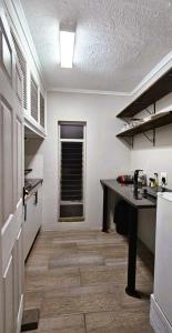 a kitchen with a counter and a table in a room at Daniel's Sunset Garden in Richards Bay