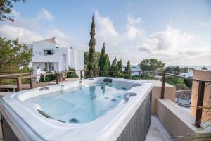 a hot tub on the balcony of a house at La Villa in Illes Balears