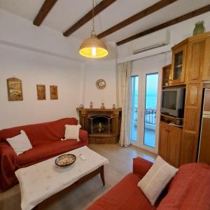 a living room with a couch and a table at Chios Studios Kalamari in Vrontádos