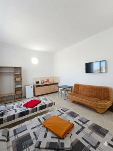 a living room with a couch and a table at У Олексія in Karolino-Buhaz