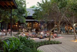 a group of people sitting in a courtyard at Lion Sands River Lodge in Sabi Sand Game Reserve