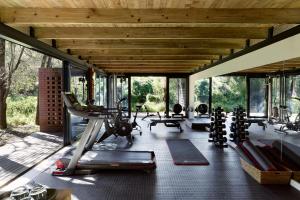 a gym with treadmills and exercise equipment in a building at Lion Sands River Lodge in Sabi Sand Game Reserve