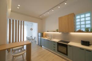 eine Küche mit Theke und Tisch und ein Esszimmer in der Unterkunft Corali 2 - Coastal Retreat in Katakolo