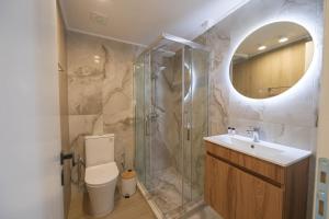 ein Badezimmer mit Dusche, Toilette und Waschbecken in der Unterkunft Corali 2 - Coastal Retreat in Katakolo