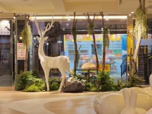 a white statue of a deer in a store window at Finders Hotel Hualien Wen Hua in Hualien City