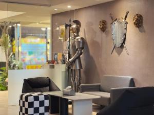 a room with a statue of a man on a wall at Finders Hotel Hualien Wen Hua in Hualien City