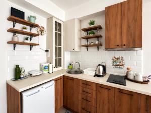 a kitchen with wooden cabinets and a sink at Central Apartments Kukoski Near Lake & Old Town in Ohrid