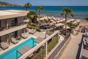 an aerial view of a resort with a swimming pool and the ocean at Riviera Boutique Hotel in Stalís