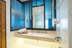 a bathroom with a sink and a large window at โฮเทลมุก in Mukdahan +36 photos