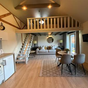 a living room with a staircase and a living room at Rasos Vila in Palanga