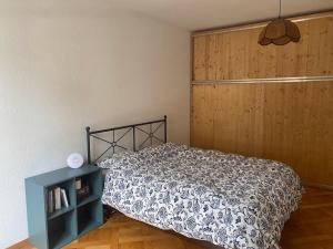 a bedroom with a bed and a wooden door at Flat 12-min walk to Bern station in Bern