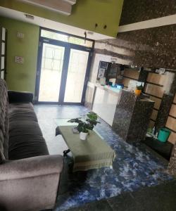 a living room with a couch and a table at SWAYAMSIDDHA continental in Kendrāparha