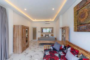 a living room with a bed and a couch at Made's Dream Villa Amed in Amed +60 photos