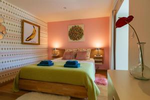 a bedroom with a bed in a room with pink walls at La Maison Pop avec Piscine Privée in Romans-sur-Isère +13 photos