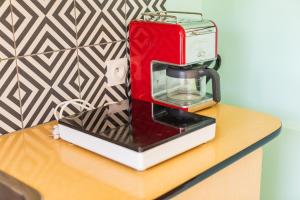 a coffee maker sitting on top of a counter at La Maison Pop avec Piscine Privée in Romans-sur-Isère