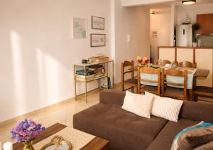 a living room with a couch and a table at Thalassia Pefkias Apartment in Xylokastro