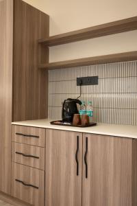 a kitchen with a counter with a toaster and bread at Mansions by HomeSlice in Bangalore +21 photos