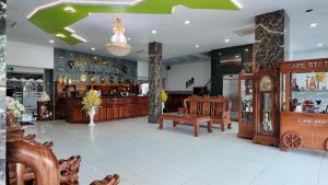 a store with a bench in the middle of a room at Balcony Superior King - Châu Giang Hotel in Ga Phú Trung