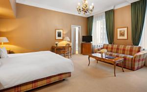 a large hotel room with a bed and a couch at Hotel Excelsior Munich in Munich +84 photos