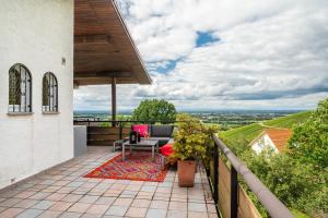 a patio with a table and chairs on a balcony at Baden-Chalet - Panoramablick in Bühl
