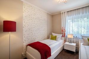 a bedroom with a white bed and a window at Baden-Chalet - Panoramablick in Bühl