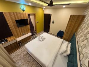 a hotel room with a bed and a tv at Hotel Mukti Residency in Mātigara