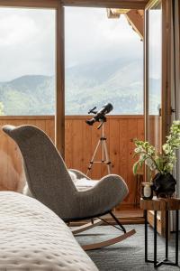 a chair in front of a window with a camera at Wierchowa Chata in Kościelisko