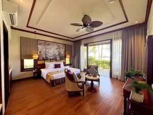 a large hotel room with a bed and a table at Sunny Beach Resort & Spa Mui Ne in Mui Ne +151 photos