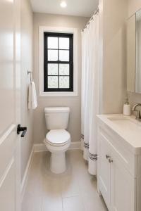 a white bathroom with a toilet and a window at Private 1BR Apt, WiFi, Reliable, Near NYC in Scotch Plains +23 photos