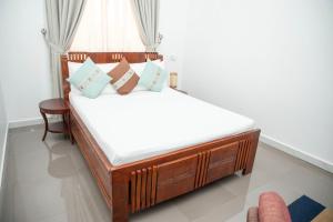 a bedroom with a bed with white sheets and pillows at Tulivu Resort in Kituoni +25 photos
