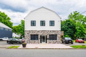 a white house with a brick at Private 1BR Apt, WiFi, Reliable, Near NYC in Scotch Plains