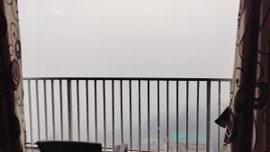 a window with a view of the ocean from a balcony at Mcleodganj Mountain View Royal india-cheapest hotel in McLeod Ganj- Near Dalai Lama temple 100m-best hotel on Temple Road! in Dharamshala