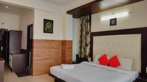 a bedroom with a large bed with red pillows at Mcleodganj Mountain View Royal india-cheapest hotel in McLeod Ganj- Near Dalai Lama temple 100m-best hotel on Temple Road! in Dharamshala +20 photos