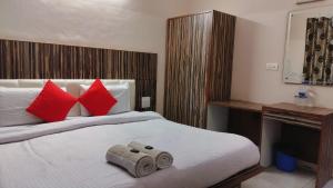 a bedroom with a large bed with red pillows at Mcleodganj Mountain View Royal india-cheapest hotel in McLeod Ganj- Near Dalai Lama temple 100m-best hotel on Temple Road! in Dharamshala