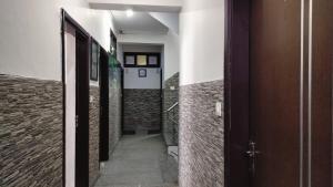 a hallway of a building with doors and brick walls at Mcleodganj Mountain View Royal india-cheapest hotel in McLeod Ganj- Near Dalai Lama temple 100m-best hotel on Temple Road! in Dharamshala